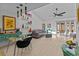 Bright and open living space features modern decor, vaulted ceilings, and sliding glass doors to an outdoor patio at 2240 Pinewood Villas Dr, Holiday, FL 34691