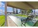 Community shuffleboard court with benches, manicured lawn, and landscaping at 2240 Pinewood Villas Dr, Holiday, FL 34691