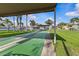 Community shuffleboard court, lawn, and landscaping at 2240 Pinewood Villas Dr, Holiday, FL 34691