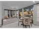 Bright sun room with table, four chairs, and modern lighting and view to outdoors at 2240 Pinewood Villas Dr, Holiday, FL 34691