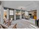 Enclosed sunroom with views of the backyard and seating area; perfect for relaxation or entertainment at 2240 Pinewood Villas Dr, Holiday, FL 34691