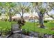 Backyard view showcasing mature trees, a green lawn and tropical foliage at 2460 Northside Dr # 708, Clearwater, FL 33761