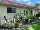 Backyard with beautiful plantings surrounding a paver patio with seating at 2460 Northside Dr # 708, Clearwater, FL 33761