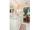 Bathroom with a double sink vanity, granite countertop, and access to the bedroom at 2460 Northside Dr # 708, Clearwater, FL 33761