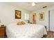 Bright bedroom with hardwood floors, light green walls, and a king size bed at 2460 Northside Dr # 708, Clearwater, FL 33761