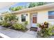 Charming condo featuring a covered entrance, lush landscaping, and a welcoming front door at 2460 Northside Dr # 708, Clearwater, FL 33761