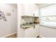 Kitchen bar area featuring granite countertop, tile backsplash, and white cabinets at 2460 Northside Dr # 708, Clearwater, FL 33761