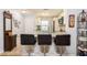 Well-lit kitchen with granite countertops, stainless steel appliances, barstool seating and white cabinets at 2460 Northside Dr # 708, Clearwater, FL 33761