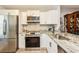 Bright kitchen with stainless steel appliances, granite countertops, white cabinets, and stylish backsplash at 2460 Northside Dr # 708, Clearwater, FL 33761
