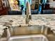 Kitchen sink with stainless steel faucet and granite countertop in the home at 2460 Northside Dr # 708, Clearwater, FL 33761