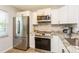 Modern kitchen featuring stainless steel appliances, granite countertops, and white cabinetry at 2460 Northside Dr # 708, Clearwater, FL 33761