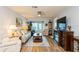 Living room with hardwood floors, neutral furniture, and TV at 2460 Northside Dr # 708, Clearwater, FL 33761