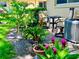Paver patio lined with lush greenery and flowering plants and outdoor seating at 2460 Northside Dr # 708, Clearwater, FL 33761