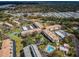Aerial view of the condo complex with buildings, parking, pool, and tennis courts at 2700 Bayshore Blvd # 1206, Dunedin, FL 34698