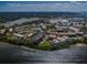 Extensive aerial view showcases the condo community near the water with lush surroundings at 2700 Bayshore Blvd # 1206, Dunedin, FL 34698
