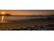 Stunning sunset view of the tranquil beach and calm ocean waters at 2700 Bayshore Blvd # 1206, Dunedin, FL 34698