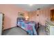 Cozy bedroom with a patterned quilt, carpet, and plenty of closet space at 2700 Bayshore Blvd # 1206, Dunedin, FL 34698