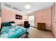 A bright bedroom features a window, dresser, and a comfortable bed at 2700 Bayshore Blvd # 1206, Dunedin, FL 34698