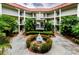 Charming courtyard with a central fountain, surrounded by lush greenery and building balconies at 2700 Bayshore Blvd # 1206, Dunedin, FL 34698
