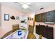 Dining area with ceiling fan features a round table and access to kitchen at 2700 Bayshore Blvd # 1206, Dunedin, FL 34698