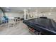 Game room offers a pool table, exercise equipment, and table with chairs, all in a well-lit space at 2700 Bayshore Blvd # 1206, Dunedin, FL 34698