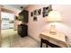 Hallway with tiled floor leading to kitchen, decorated with framed photos and accent table at 2700 Bayshore Blvd # 1206, Dunedin, FL 34698