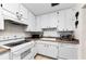 A well-lit kitchen offers clean white cabinets and appliances for easy cooking at 2700 Bayshore Blvd # 1206, Dunedin, FL 34698