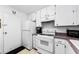 All-white kitchen offers efficient appliances and ample storage at 2700 Bayshore Blvd # 1206, Dunedin, FL 34698