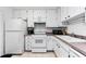 Bright kitchen with white appliances, ample cabinet space and tiled flooring at 2700 Bayshore Blvd # 1206, Dunedin, FL 34698