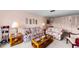Cozy living room featuring floral print sofa, matching chair, and glass coffee table at 2700 Bayshore Blvd # 1206, Dunedin, FL 34698
