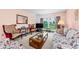 Comfortable living room featuring a large window, stylish seating, and a cozy atmosphere at 2700 Bayshore Blvd # 1206, Dunedin, FL 34698