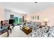 A cozy living room features a floral sofa, lamps, and a view to the outside at 2700 Bayshore Blvd # 1206, Dunedin, FL 34698