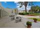 Patio space with stone seating, umbrellas, and landscaped planters, perfect for relaxing outdoors at 2700 Bayshore Blvd # 1206, Dunedin, FL 34698
