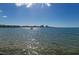 Scenic waterfront view featuring sparkling water and distant buildings under a bright blue sky at 2700 Bayshore Blvd # 1206, Dunedin, FL 34698