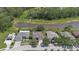 An aerial view displays the community, highlighting the home's proximity to a large pond and green spaces at 27826 Sora Blvd, Wesley Chapel, FL 33544