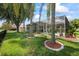 Lush backyard features mature trees, a well-manicured lawn, and a screened-in pool area for outdoor enjoyment at 27826 Sora Blvd, Wesley Chapel, FL 33544