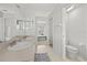 Bathroom featuring double sinks, toilet room, and connecting bedroom at 27826 Sora Blvd, Wesley Chapel, FL 33544