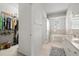 Bathroom featuring double sinks, soaking tub, and walk in closet at 27826 Sora Blvd, Wesley Chapel, FL 33544