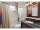 Well-maintained bathroom with tub, shower, and dark vanity with a matching framed mirror at 27826 Sora Blvd, Wesley Chapel, FL 33544