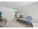 Bedroom with vaulted ceilings, ceiling fan, tv, and ensuite bathroom at 27826 Sora Blvd, Wesley Chapel, FL 33544