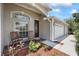 Inviting front porch with seating, complemented by well-maintained landscaping and a three-car garage at 27826 Sora Blvd, Wesley Chapel, FL 33544