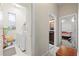 Bright hallway featuring a laundry room and connecting doors to the bathroom and bedroom at 27826 Sora Blvd, Wesley Chapel, FL 33544