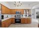 Kitchen with stainless steel appliances, granite counter tops and a view into the living room at 27826 Sora Blvd, Wesley Chapel, FL 33544