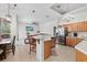 Spacious kitchen overlooking the Gathering and dining rooms features stainless appliances and tile flooring at 27826 Sora Blvd, Wesley Chapel, FL 33544