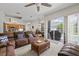 Open-concept living room and kitchen area with wood cabinets and plenty of natural light at 27826 Sora Blvd, Wesley Chapel, FL 33544