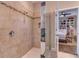 Bathroom featuring tiled shower with decorative accent wall adjacent to the main bedroom at 3037 Riders Pass, Odessa, FL 33556