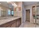 Modern bathroom featuring a double vanity, tile floors, and a glass-enclosed shower at 3037 Riders Pass, Odessa, FL 33556