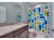 Well-lit bathroom featuring a granite countertop vanity, toilet, and shower with a colorful whale themed curtain at 3037 Riders Pass, Odessa, FL 33556