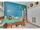 Cozy bedroom with a star themed accent wall, twin bed, and closet for ample storage at 3037 Riders Pass, Odessa, FL 33556
