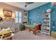Bright bedroom with a blue accent wall, whimsical star decals, and a cozy twin bed adorned with stuffed animals at 3037 Riders Pass, Odessa, FL 33556